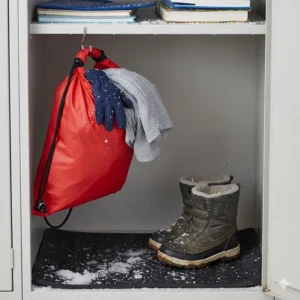 A waterproof drawstring dry bag used for separating wet mittens and snowy gym clothes inside a school locker.