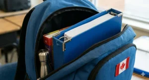 Close-up of a labeled 5 subject binder for grade 7. / Gros plan sur un classeur 5 matières étiqueté pour la 7e année.